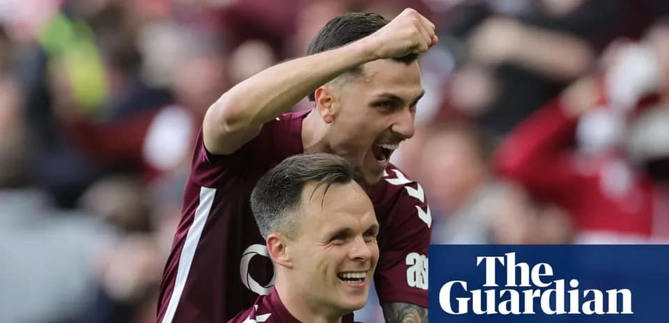 Two football players celebrating a goal together