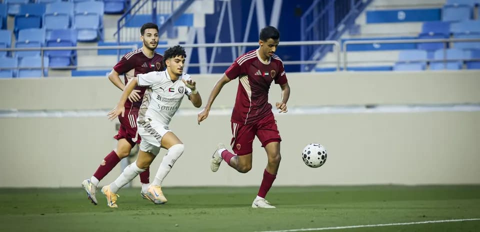 Players competing for the ball in U23 match