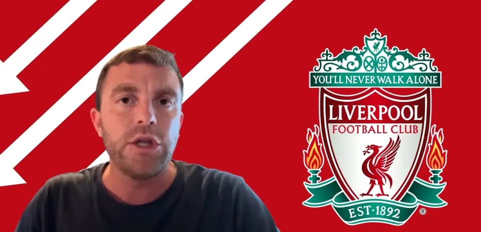 Man speaking with Liverpool FC logo in background