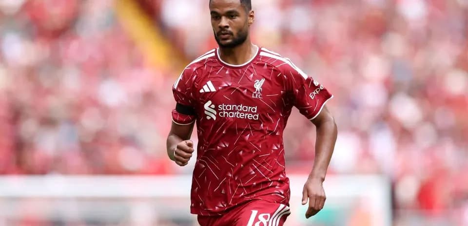 Player running on the pitch in Liverpool kit