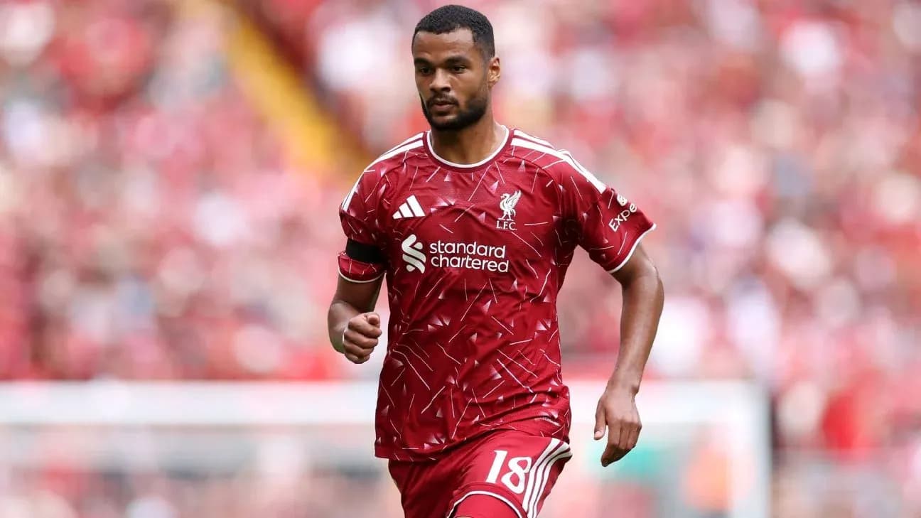 Player running on the pitch in Liverpool kit