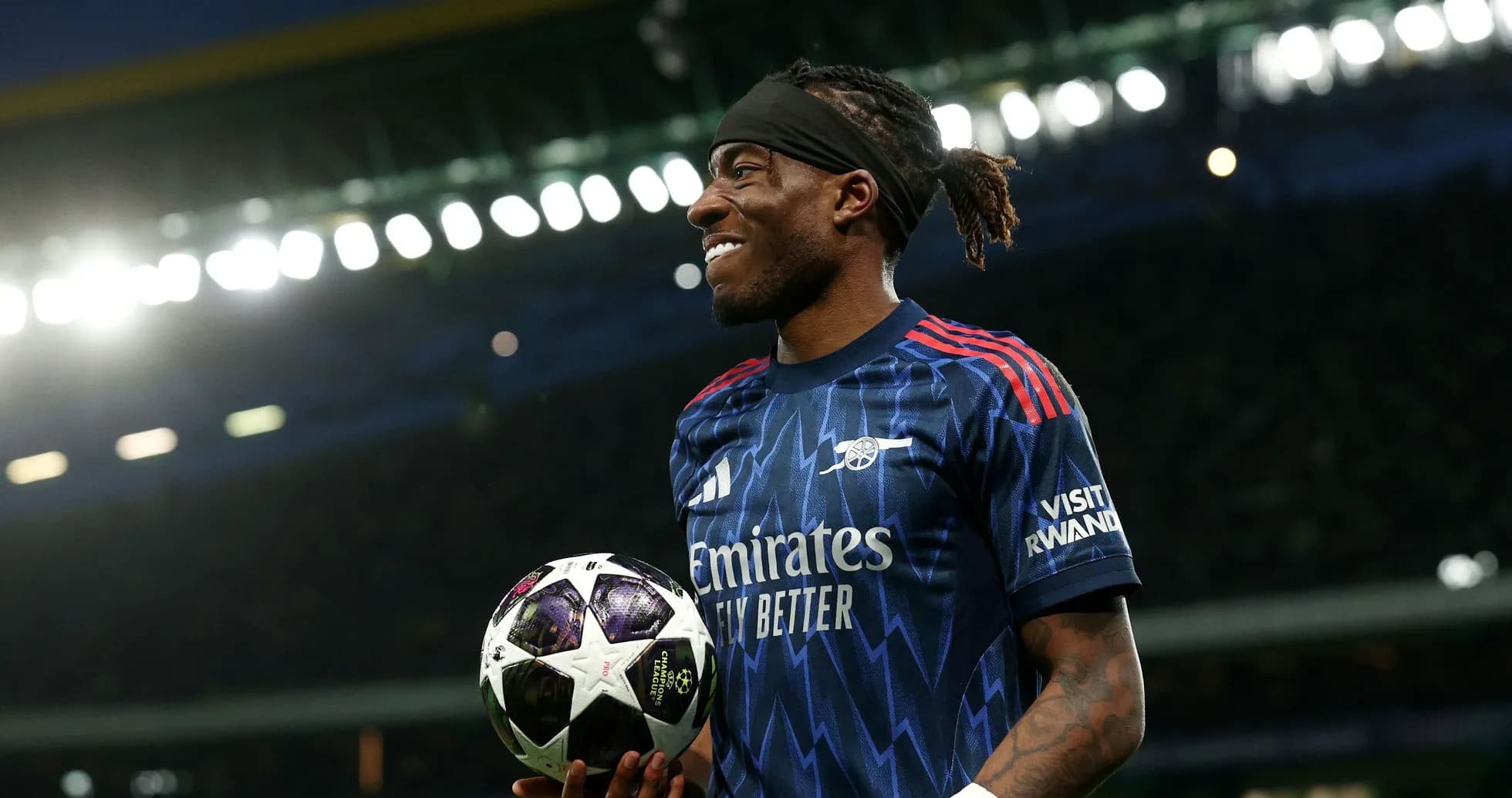 Player holding a UEFA Champions League ball on pitch