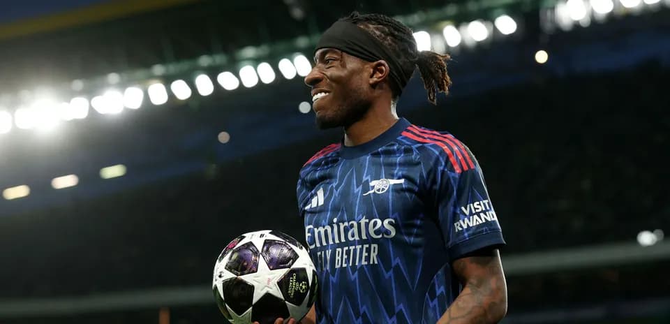 Player holding a UEFA Champions League ball on pitch