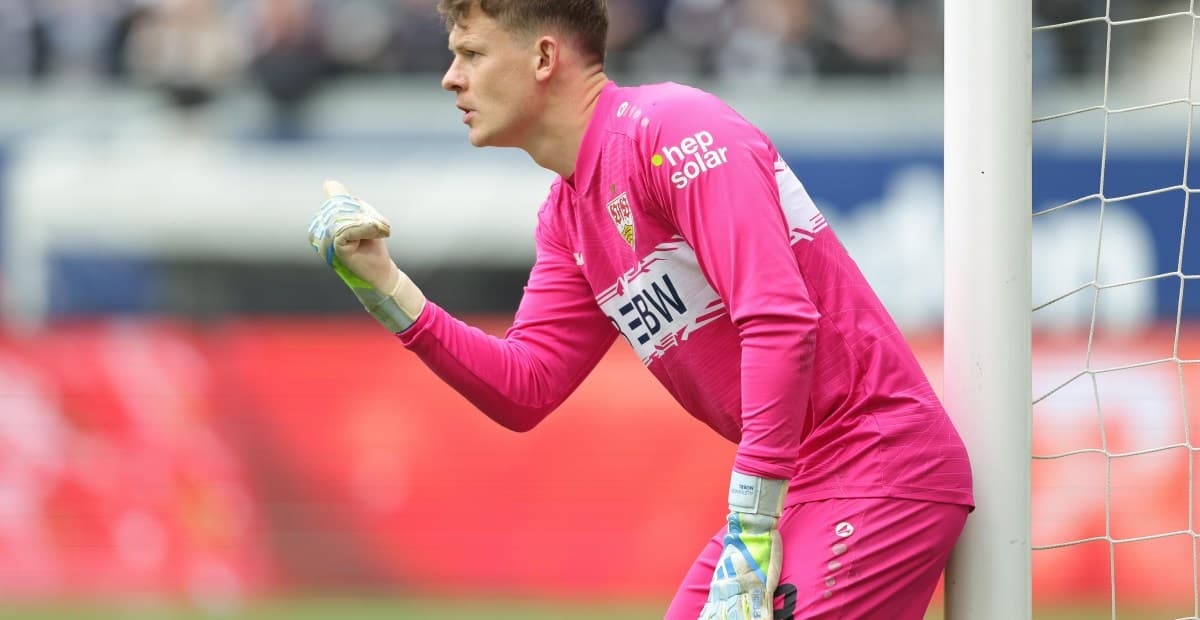 Goalkeeper in pink kit directing play during match