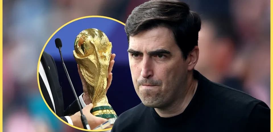 Coach with serious expression near World Cup trophy