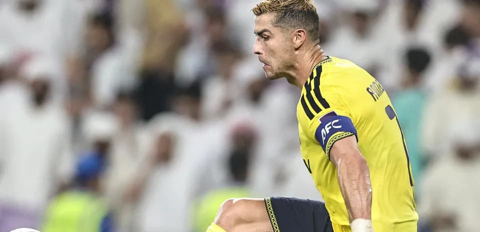Player in yellow jersey kicking a soccer ball