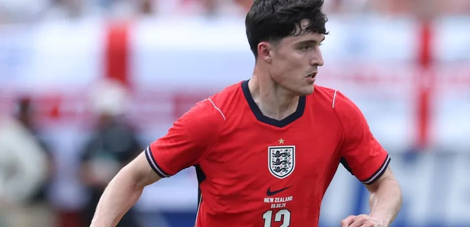 Player in red England jersey running on field