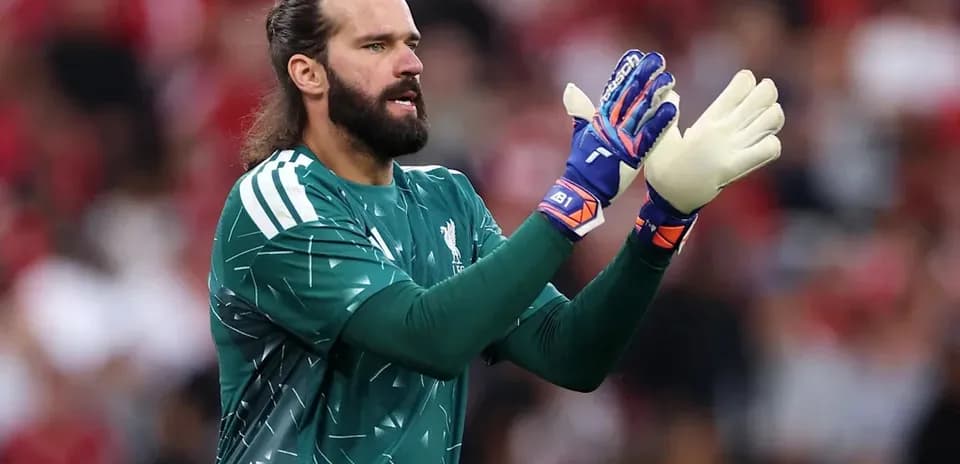 Goalkeeper in green kit gesturing during match