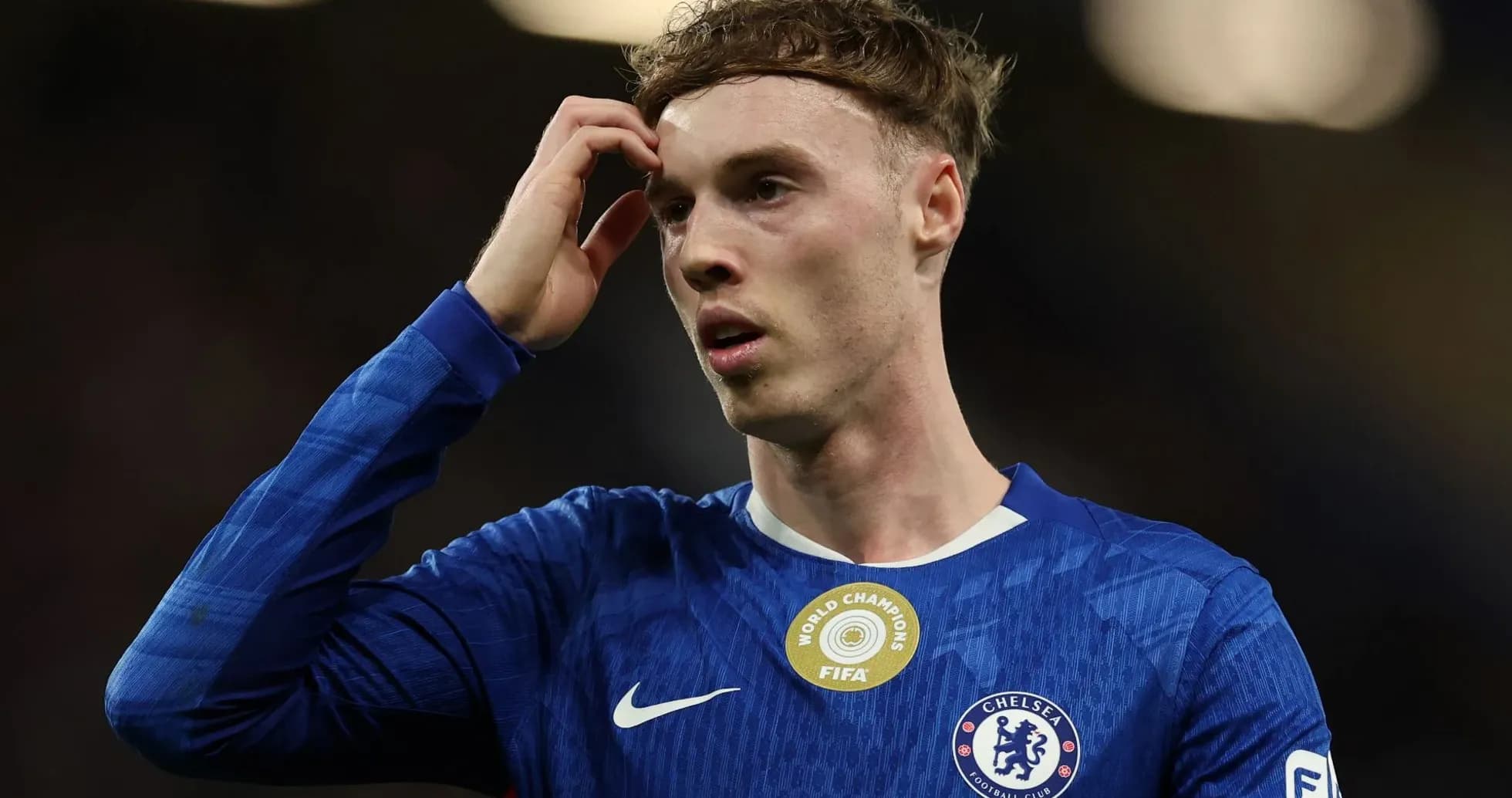 Player in Chelsea kit during match, looking concerned
