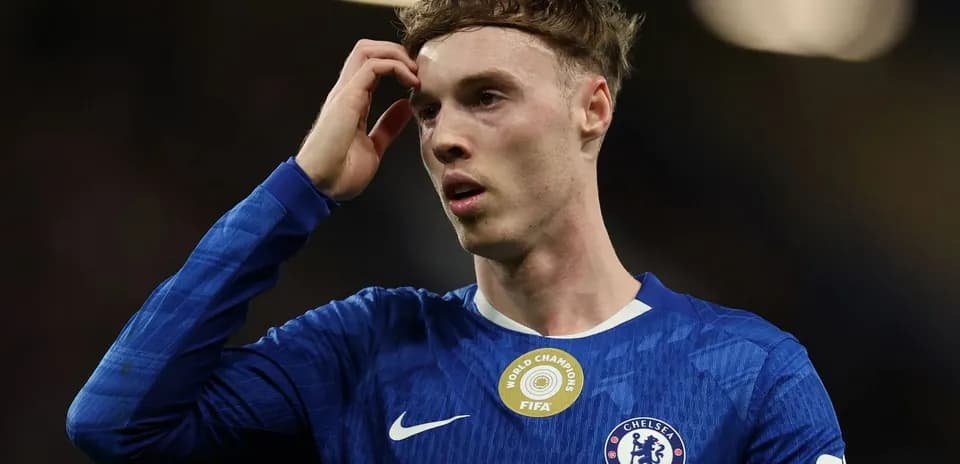 Player in Chelsea kit during match, looking concerned