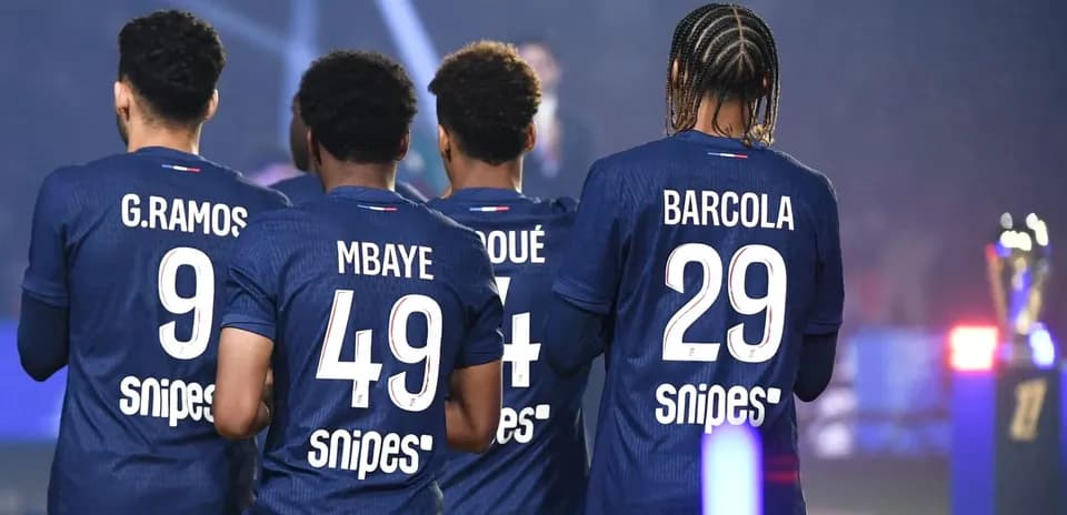 Players in blue jerseys celebrating with trophies