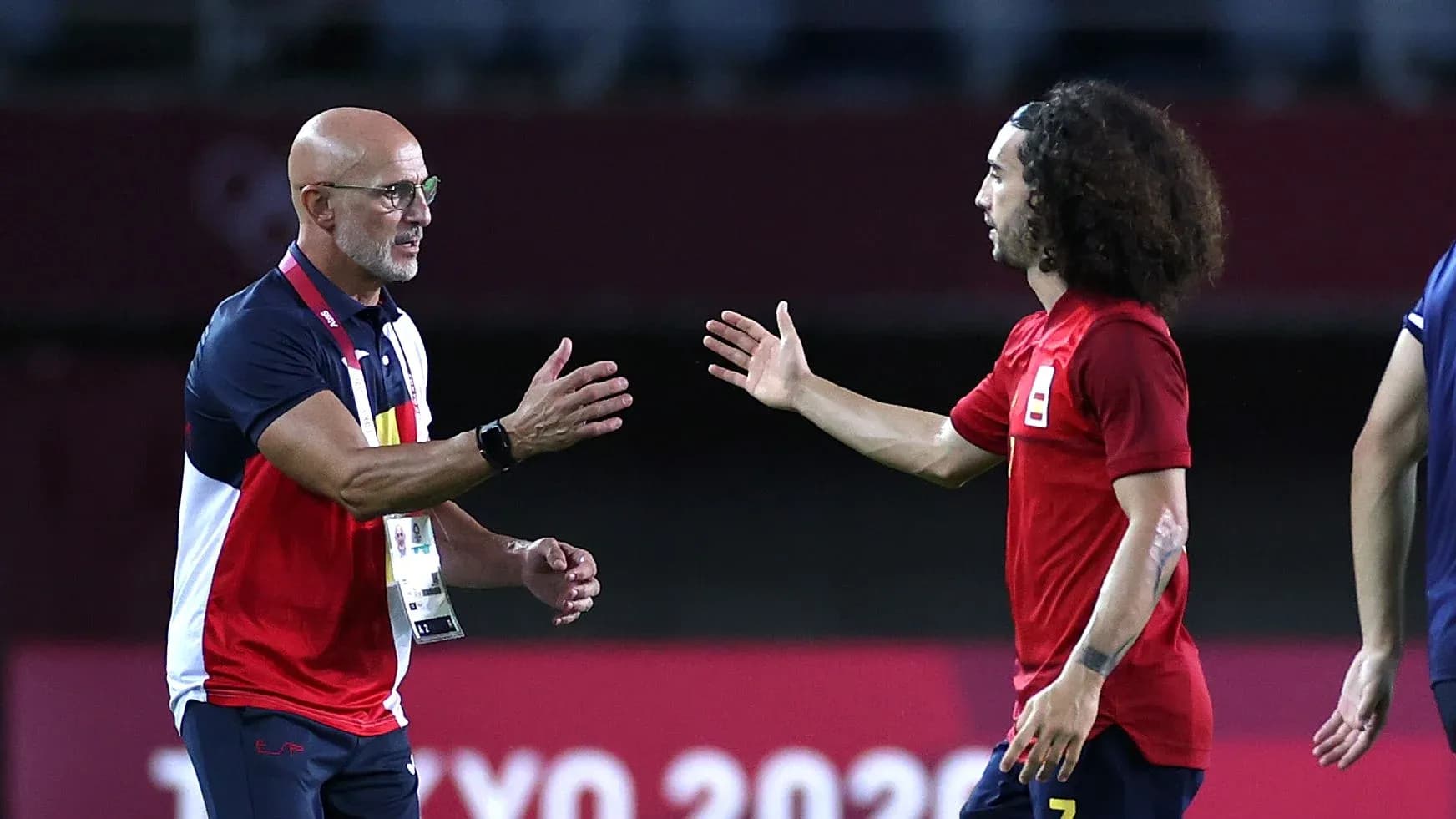 Coach and player greeting on the field