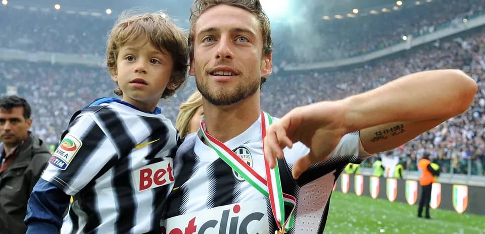 Player celebrating with child after match