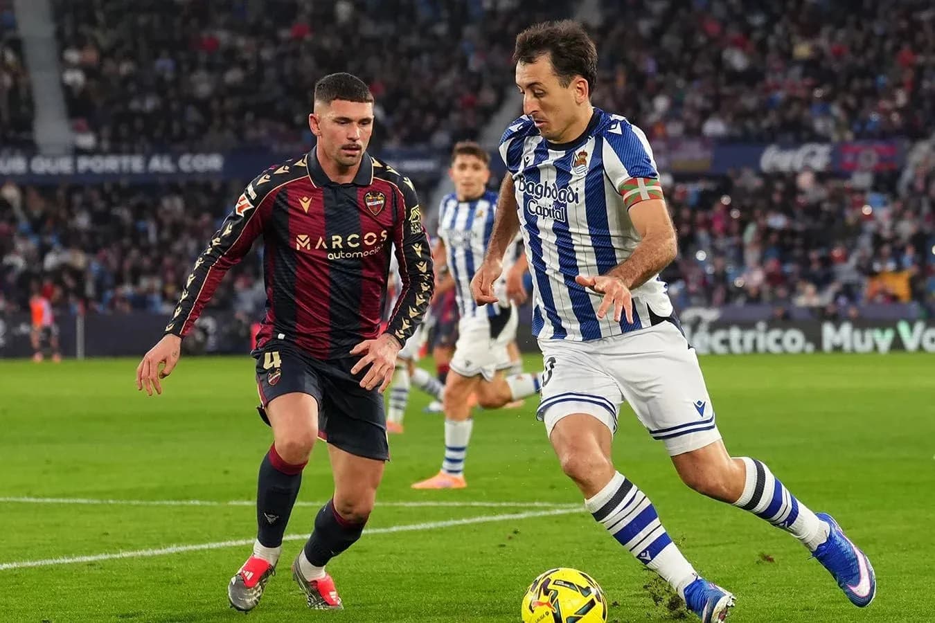 Real Sociedad player dribbling past Levante opponent