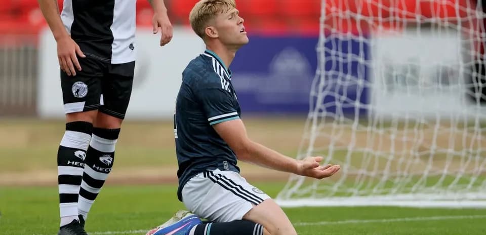 Player kneeling on pitch after missed opportunity