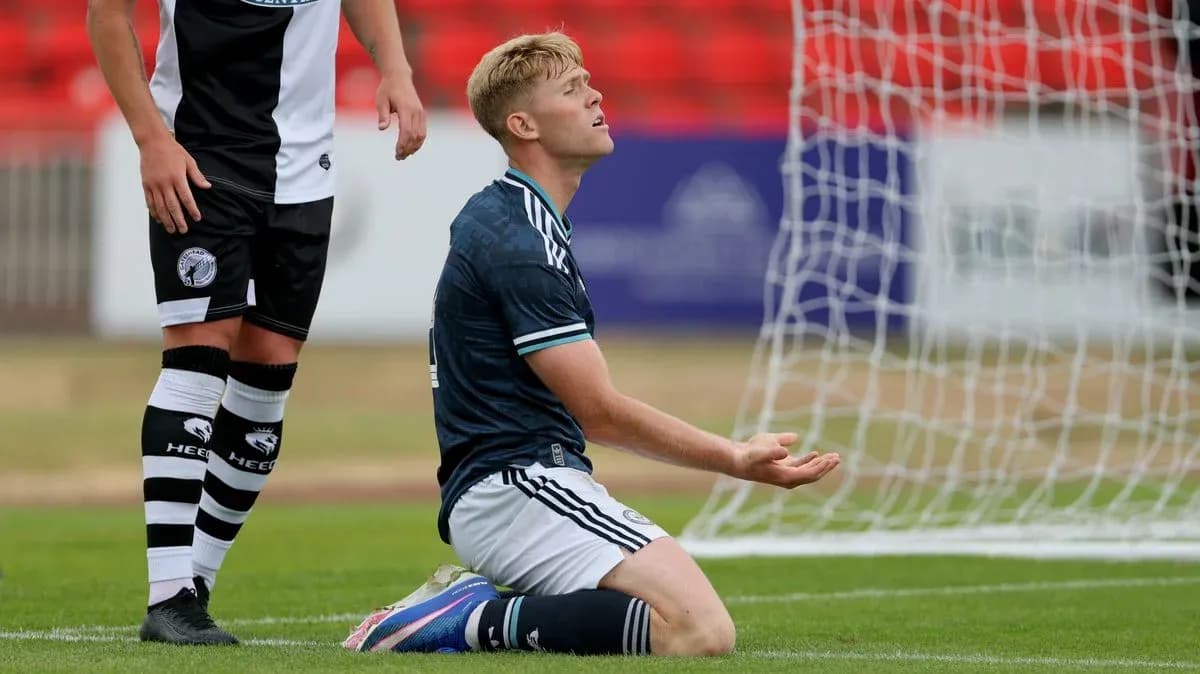 Player kneeling on pitch after missed opportunity