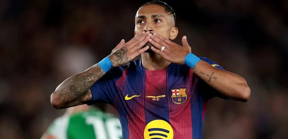 Player celebrating with kiss gesture on pitch
