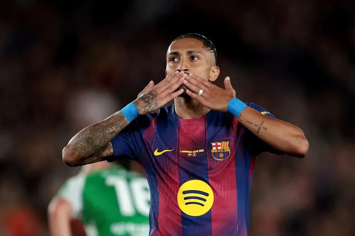 Player celebrating with kiss gesture on pitch