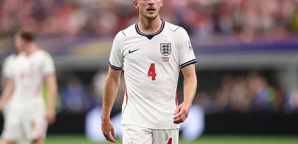 Player in England jersey walking on the pitch
