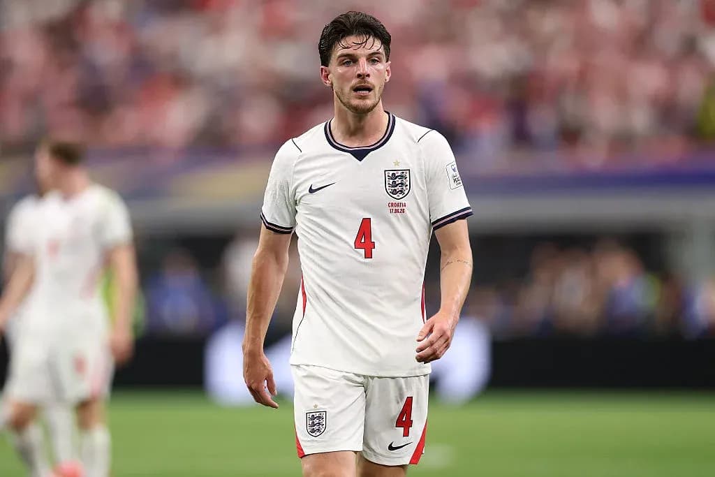Player in England jersey walking on the pitch