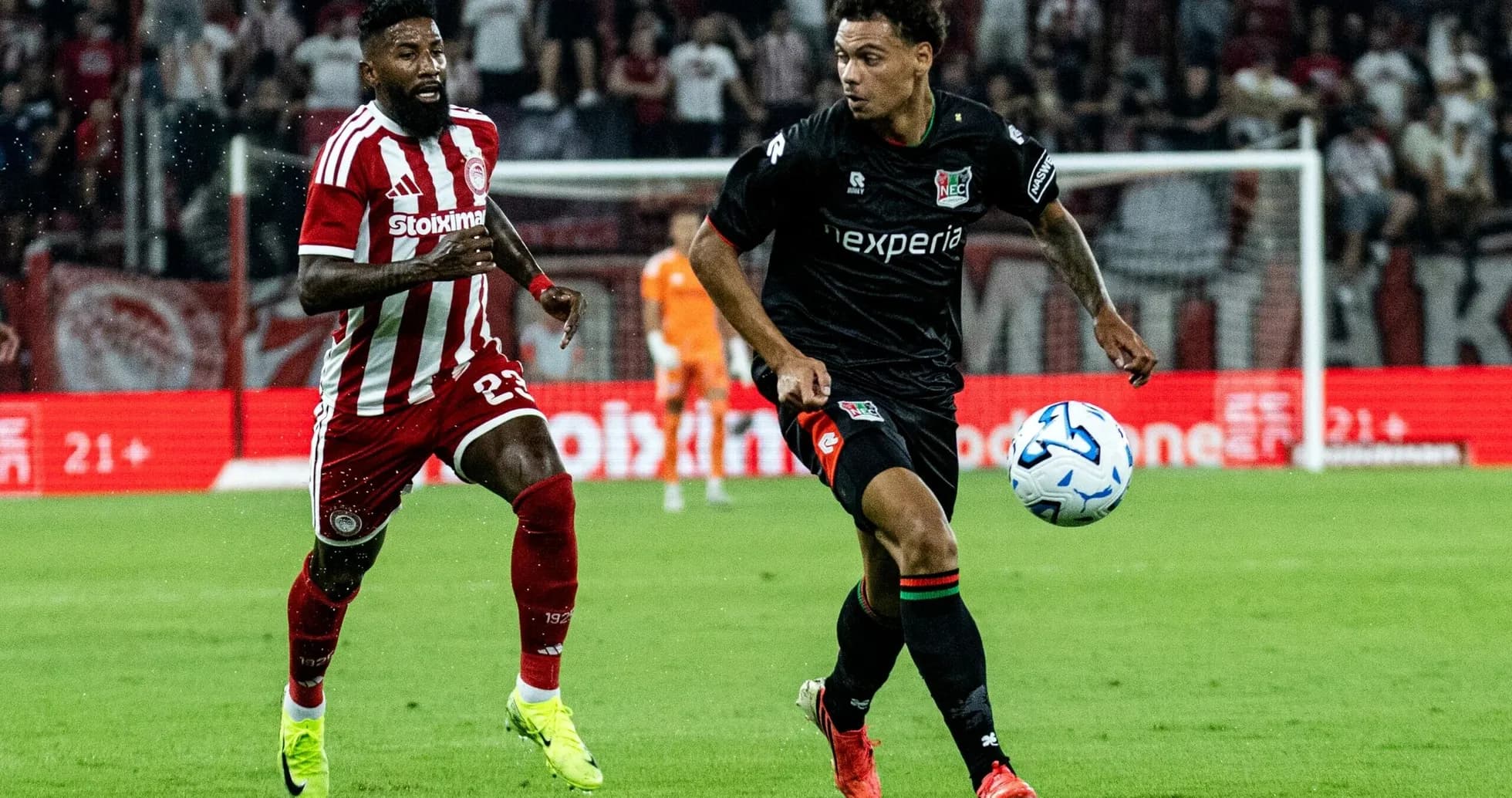 NEC Nijmegen player dribbling past Olympiakos defender