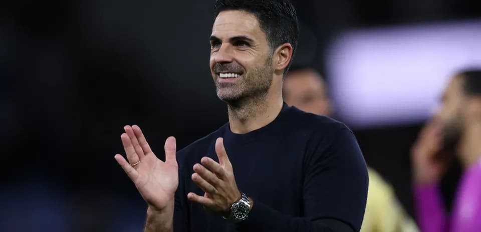 Coach applauding during match with players in background