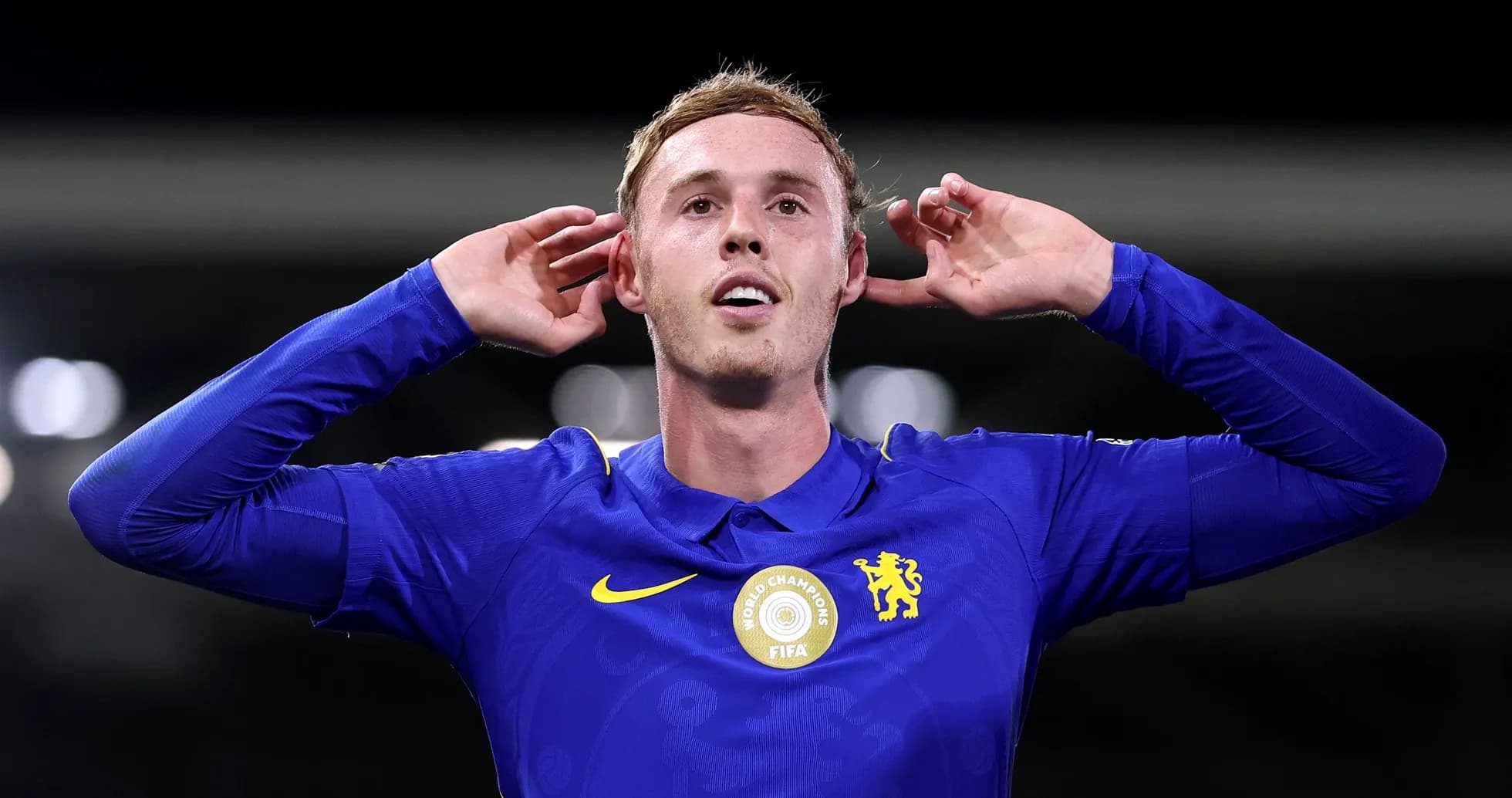 Player celebrating with hands to ears in blue jersey