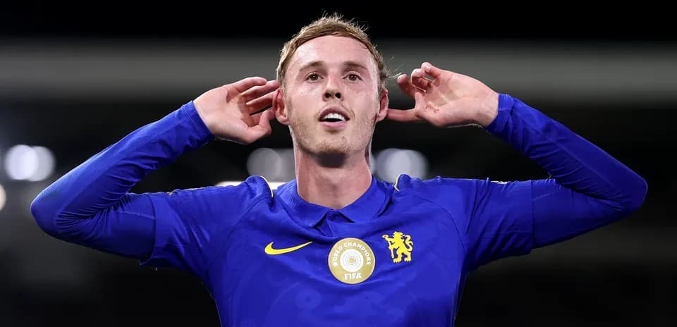 Player celebrating with hands to ears in blue jersey