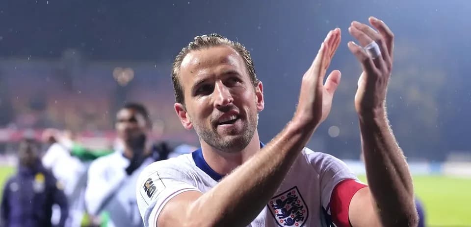 Player applauding fans after a match in rain