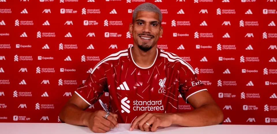 Player signing contract at Liverpool FC announcement event