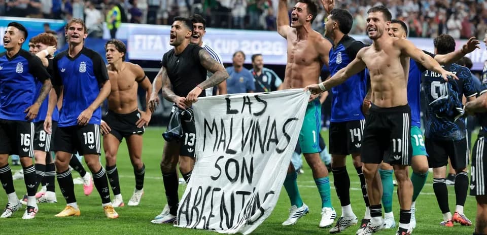Argentinian players celebrating with banner after victory