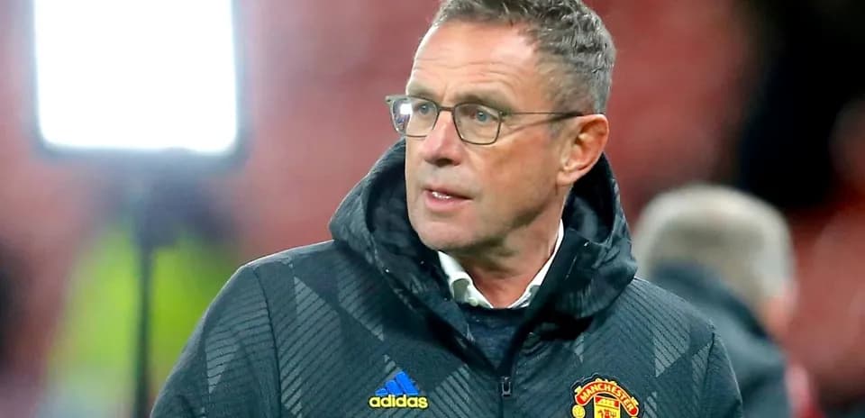 Manager wearing Manchester United jacket on sideline