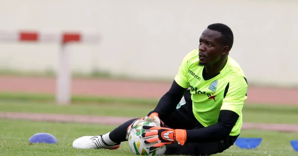Goalkeeper training on the pitch, catching a ball