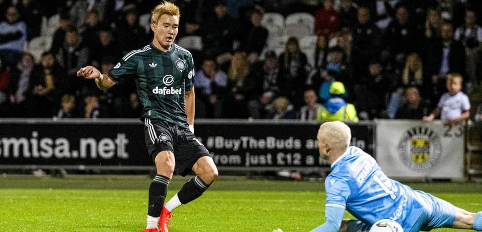 Player dribbling past goalkeeper during match action