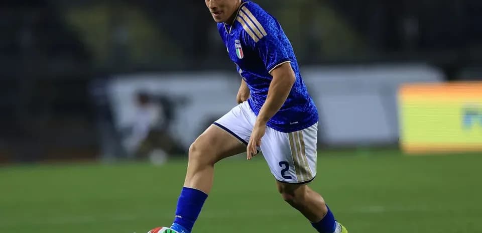 Player dribbling the ball on the pitch