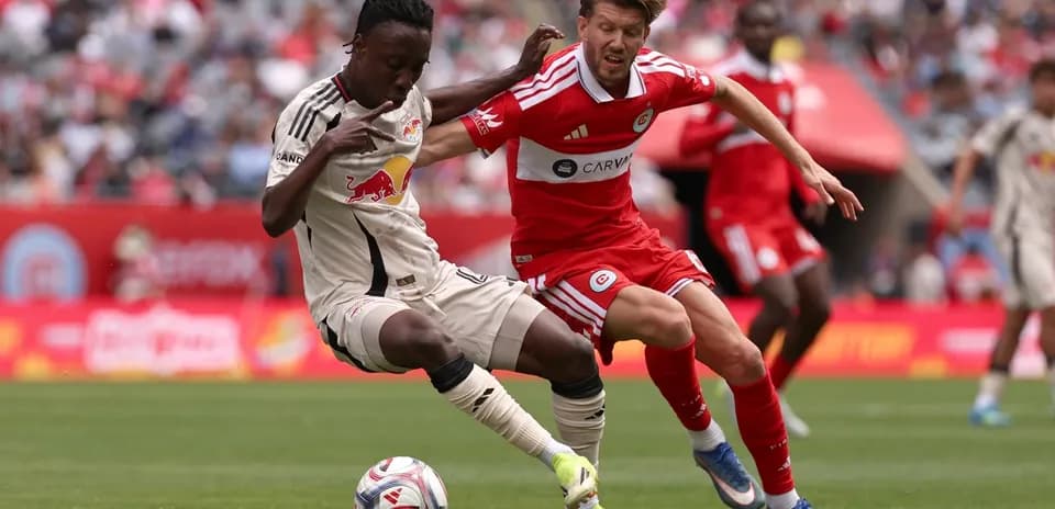 New York Red Bulls player challenging Chicago Fire opponent