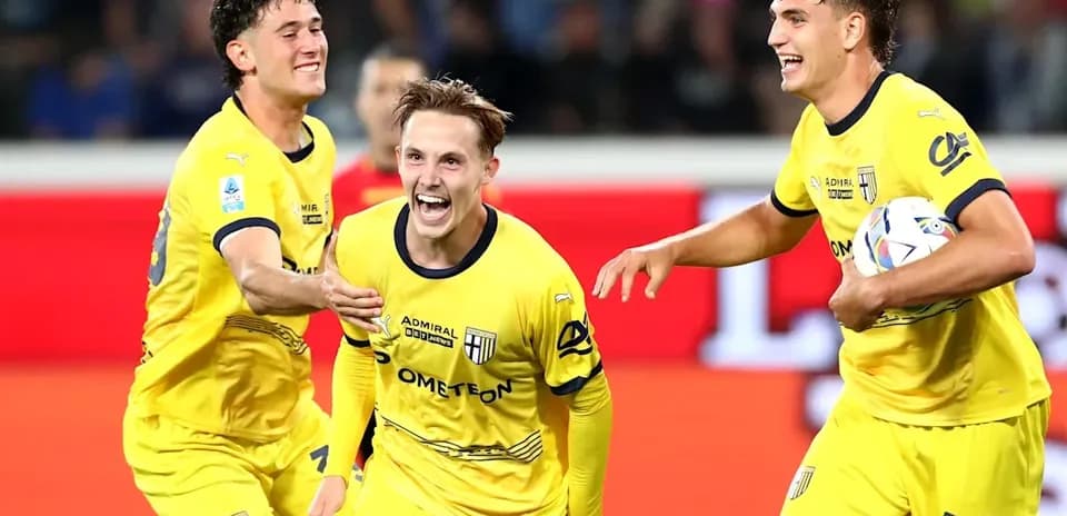 Three players celebrating a goal in yellow jerseys