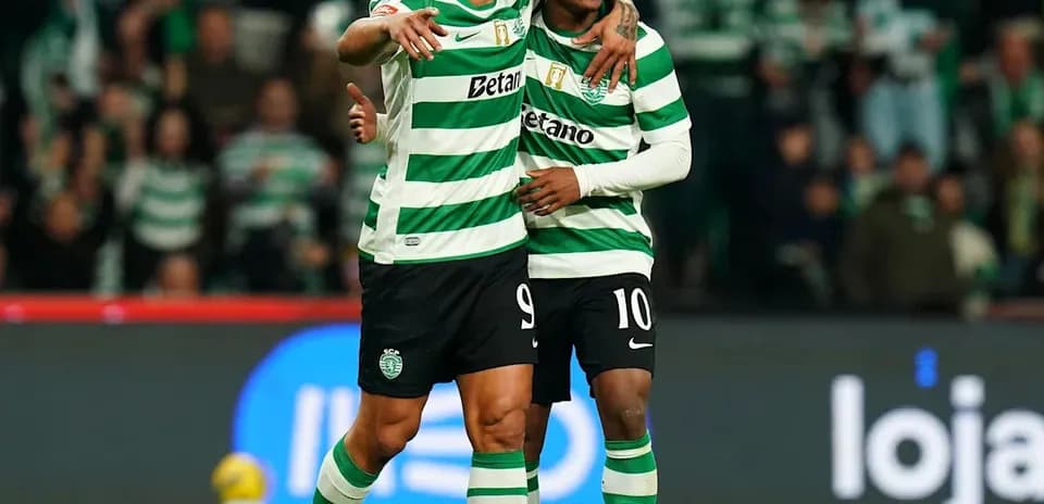 Two Sporting players celebrating a goal on the pitch