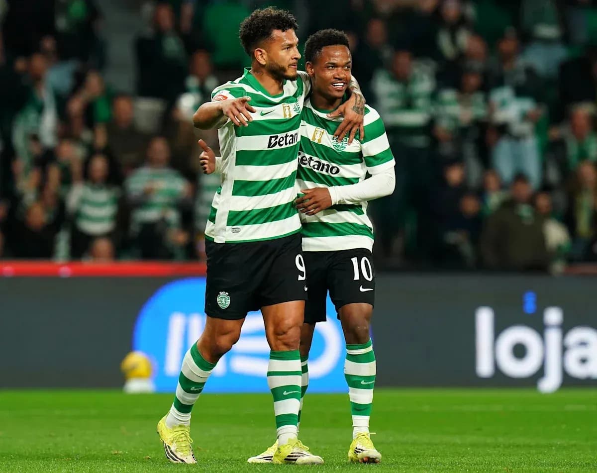 Two Sporting players celebrating a goal on the pitch