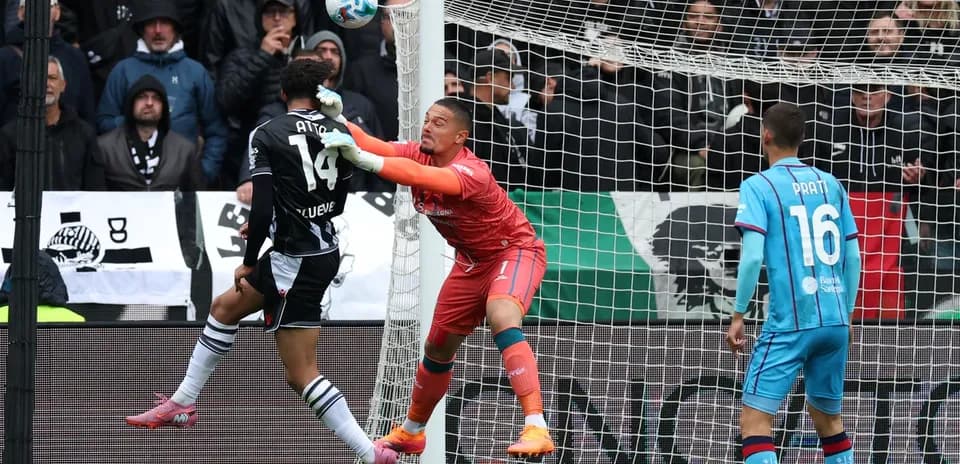 Goalkeeper attempting to block a shot on goal
