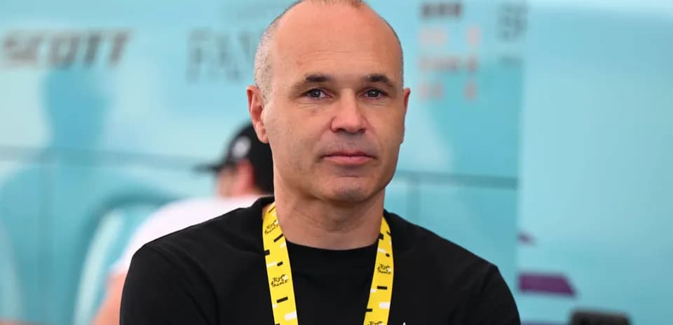 Man with lanyard at cycling event backdrop