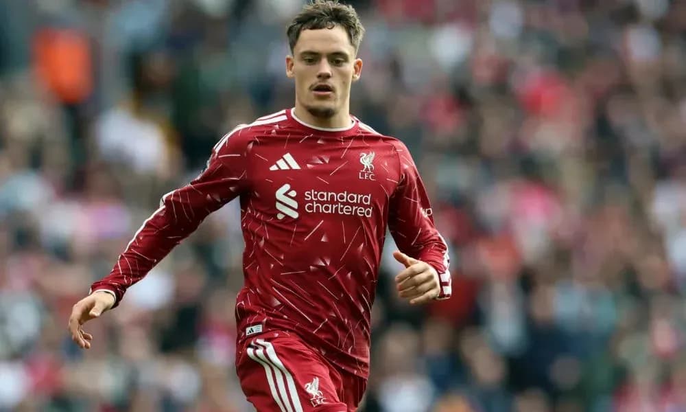 Player running on pitch in Liverpool kit