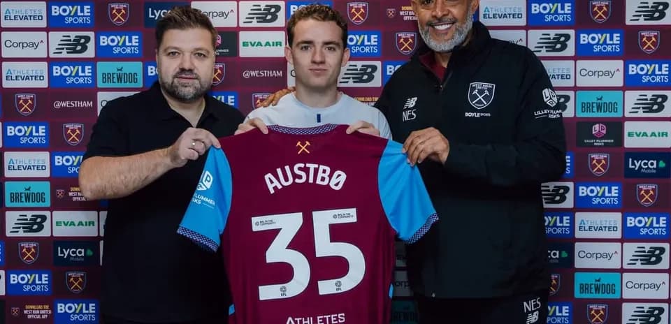 Player holding jersey with name Austbø at signing event