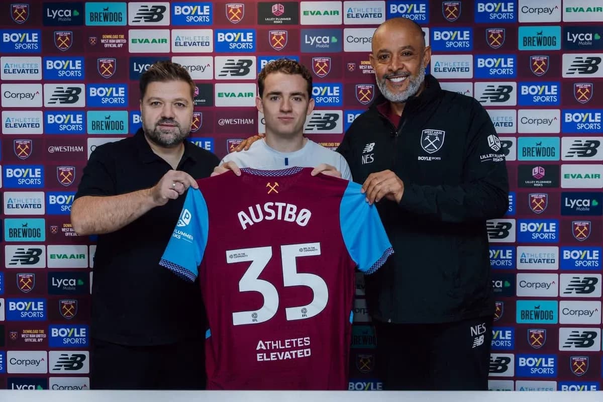 Player holding jersey with name Austbø at signing event