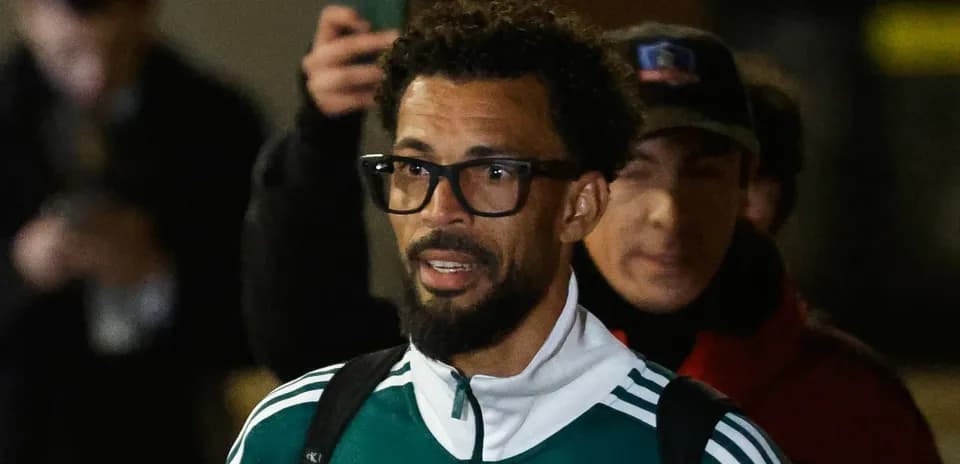Player wearing glasses arriving at venue