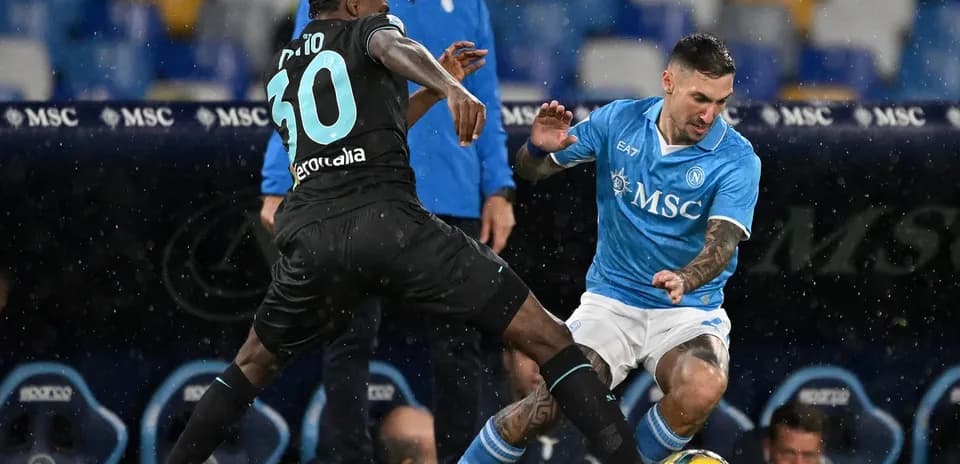 Napoli player tackling Lazio opponent during match