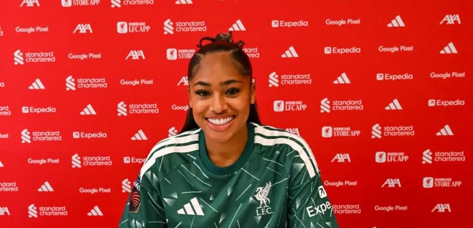 Player smiling at press conference with sponsor backdrop