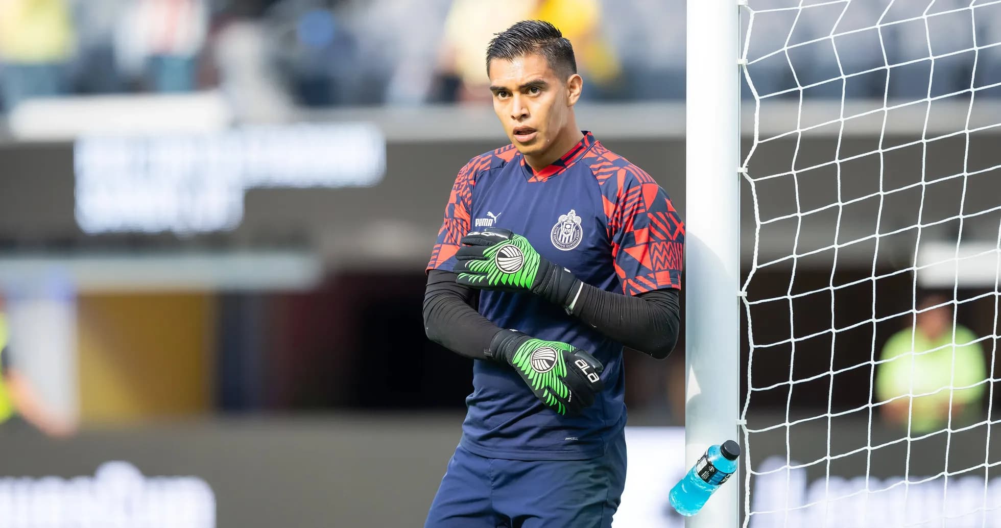 Goalkeeper preparing for the match beside the goal