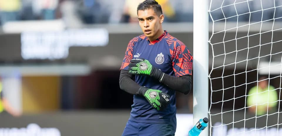 Goalkeeper preparing for the match beside the goal