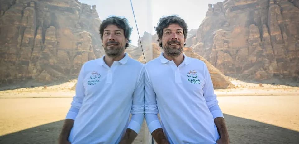 Man in white polo shirt standing in desert
